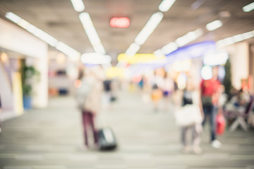 Blurred background : Traveler with baggage at airport terminal b