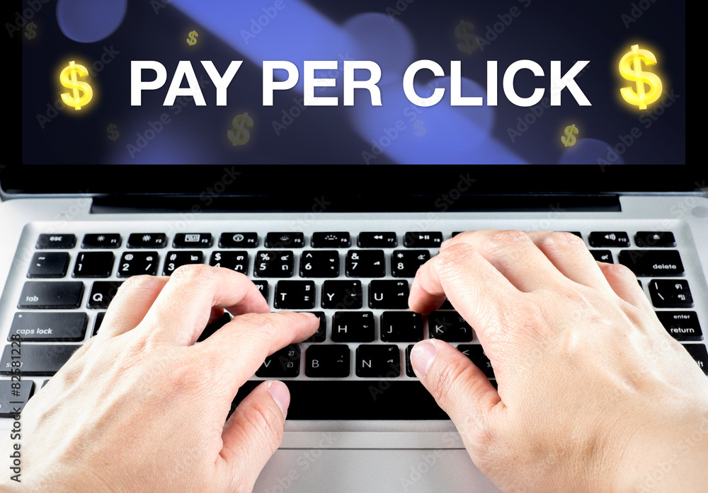 Poster pay per click (ppc) word on notebook screen with hand type on ke