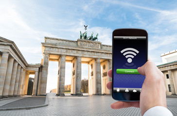 Person Hand With Mobile Phone At Brandenburg Gate © Andrey Popov