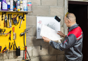 Mechanic worker studying his instructions