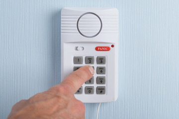 Person's Hand Entering Code