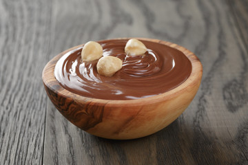 chocolate hazelnut creamin wood bowl, on old table