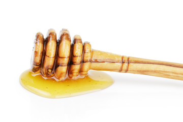 natural olive wood dipper with honey isolated