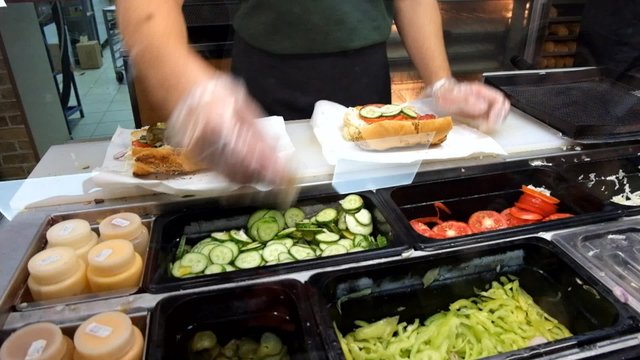 Sandwiches preparation in local fast food store.