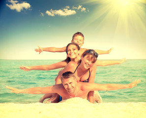 Happy family having fun at the beach. Joyful family