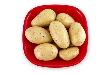 Young potatoes in red bowl isolated on white