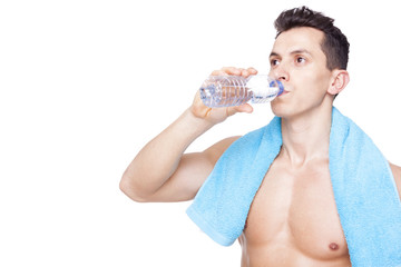 Fitness man drinking a bottle of water, isolated on white backgr