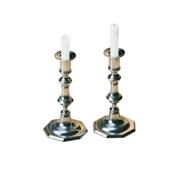 Vintage candelabras with wax candles isolated on white 