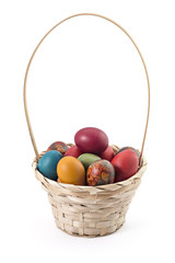 Fototapeta na wymiar Basket with easter eggs on white background