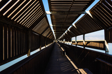 Covered wooden bridge with windows for bird watching