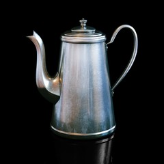 Vintage coffee kettle on black background 
