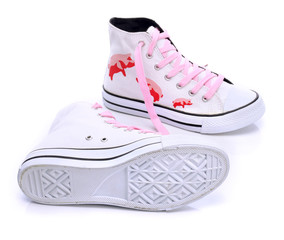 Youth sneakers with printed pigs on a white background