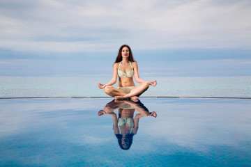 Young beautiful brunette girl in a tropics