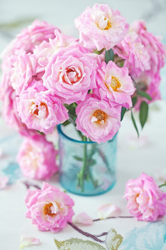 Beautiful fresh pink roses on a table. light background.