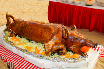 Decorated and roast suckling pig on a table on banquet.  © frolova_elena