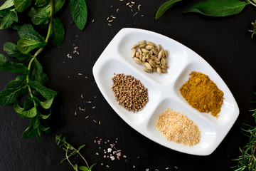 aromatic herbs and spices over slate sheet