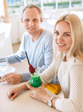 Pretty couple dating moment in cozy sunny restaurant