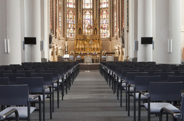 Fototapeta na wymiar Chairs In Front Of Altar In Church