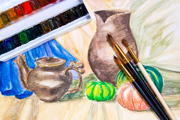 Paints with brushes on the watercolors painting.