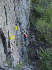 A young girl engaged in rock climbing.