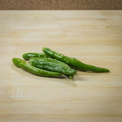 Green peppers  on wooden table