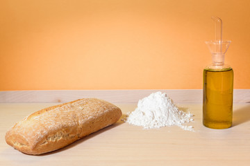 ciabatta bread on chopping board with olive oil and flour
