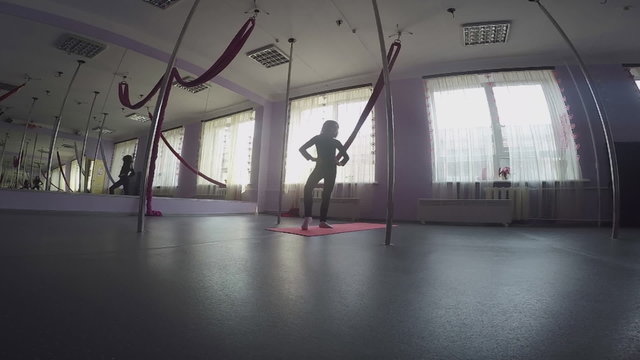 child doing warm-up ankle exercises at dance class