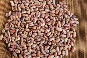 raw dried beans on a wooden surface