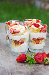Cheese, strawberry, banana, cornflakes on the table. 