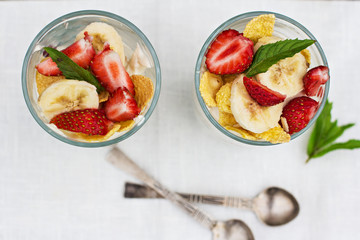 Cheese, strawberry, banana, cornflakes on the table. 