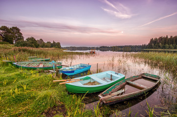 Five old boats on the lake shore
