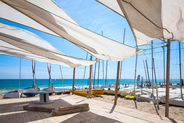 Awnings in sails shape covering relax area on beach