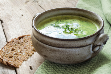 green soup with broccoli, arugula and spinach in a ceramic bowl