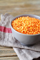 Raw red lentils in a bowl on napkin