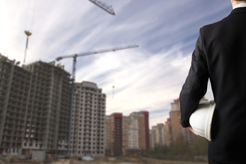 Fototapeta premium Close up of engineer hand holding white safety helmet for worker