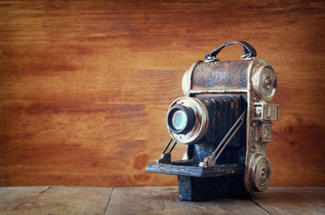 vintage old decorative camera on brown wooden background