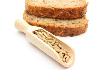 Natural rye grain on wooden spoon and pieces of bread