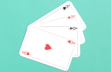Composition of four aces on green background