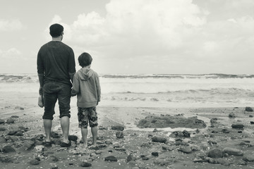 father and son walking on the beach