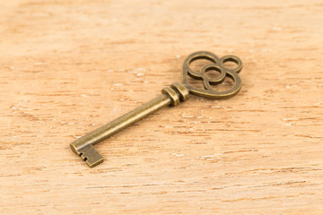 Antique key on wooden background