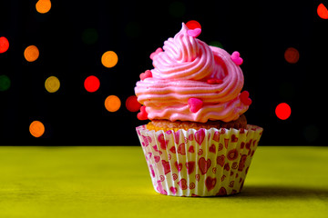 Delicious birthday pink cupcake on light background