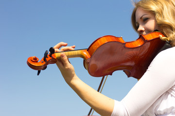 Girl playing on the violin outdoors. Musician for the wedding