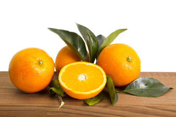 oranges with leaves on wood