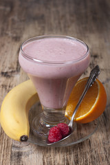 Smoothie of banana, orange juice , frozen raspberry   with yogur