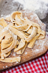 Homemade spaghetti, pasta or noodles on wooden table. 