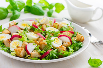 Salad with chicken, croutons, radish and quail eggs