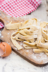 Homemade spaghetti, pasta or noodles on wooden table. 