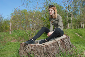 Pretty young girl walks in forest