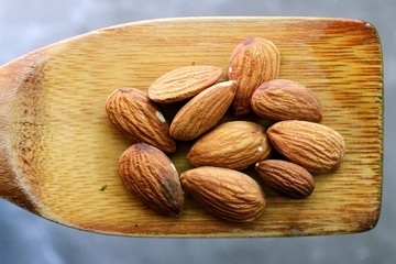 Almonds on wooden spoon