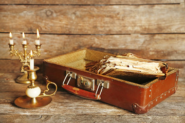 Old wooden suitcase with old books on wooden background